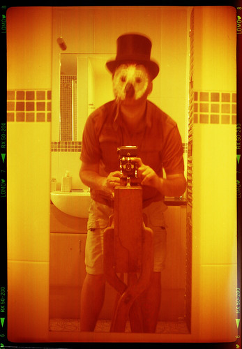 reflected self-portrait with Kershaw Penguin camera, top hat and owl mask by pho-Tony