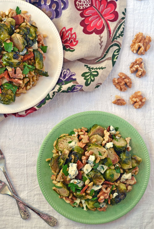 Warm Brussels sprouts salad on white and green plates