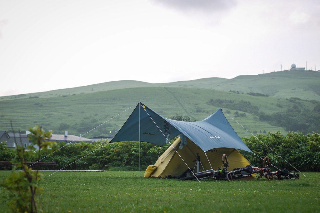 Tent and tarp at the Kushuko-han Campground at the north of Rebun Island, Hokkaido, Japan