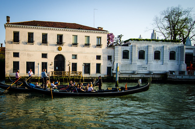 Gondolas float past the Peggy Guggenheim museum on a tour of the Grand Canal.