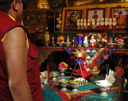 Tibetan Buddhist monk looking at the torma offerings for Vajrayogini initiation, shrine room, Sakya Lamdre, Tharlam Monastery of Tibetan Buddhism, Boudha, Kathmandu, Nepal by Wonderlane