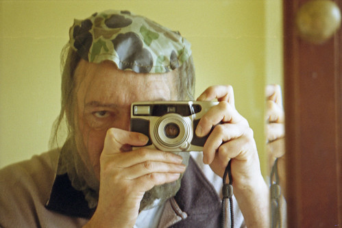 reflected self-portrait with Konica Z-UP 150 camera and camouflage net by pho-Tony