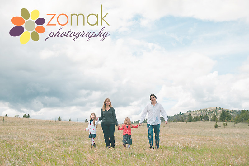 Family walks hand in hand through their property during their family session in Helena, Montana