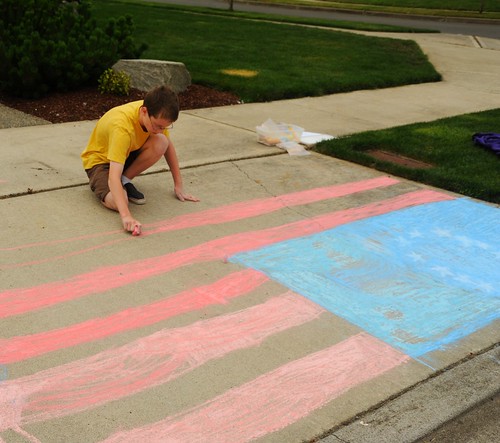 Ezra drawing an American flag on the 4th of July, memorial of the Revolutionary War, 13 stars, red white and blue, sidewalk art, West Olympia, Washington, USA by Wonderlane