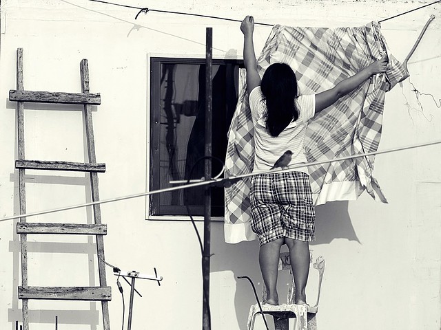 Woman hanging blanket. Photographed by Bernard Eirrol Tugade