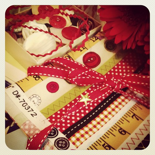A box of vintage buttons and fabric with buttons on it!   Take a peak at the selvage! I know, awesome right!