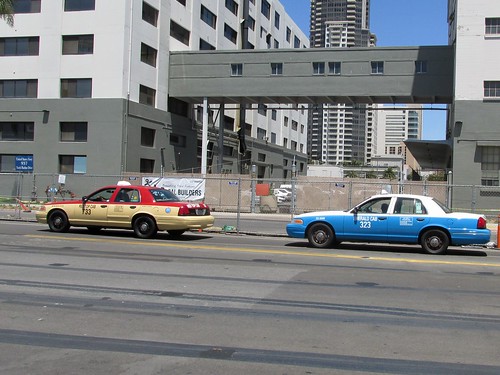 Two local taxi cabs pass by near the harbor.  San Diego California.  June 2013. by Eddie from Chicago