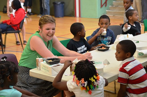 The Director of USDA’s Center for Faith-Based and Neighborhood Partnerships, Norah Deluhery, eats lunch with kids at a Philadelphia Archdiocese’s Nutritional Development Services (NDS) summer food service site.  The Center maintains integral relationships with partners like NDS to ensure disadvantaged children don’t go hungry when school is out.