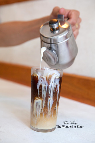 Pouring the condensed milk syrup onto the Vietnamese coffee
