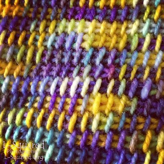 Close up of stitching showing off the many colors created by the blending of the dyes in the Starry Night yarn