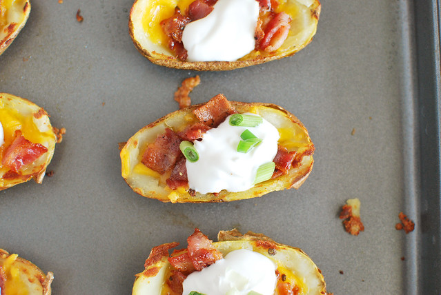 Potato Skins recipe! A classic! Filled with cheddar cheese, bacon, sour cream, and green onions! These are always a hit at football parties!