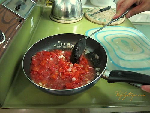 Stirring in the Diced Tomatoes.