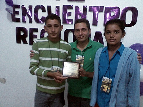 Pedro and Karelis receive award from Pastor Miguelangel Perez.