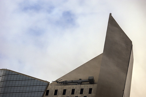 A close up of AlHamra Tower's tip cutting through the fog