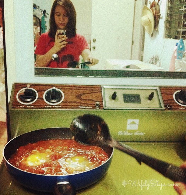 Cooking dinner. With Selfie. Haha. Cooking poached eggs in tomato sauce.
