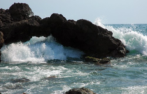 A wave joyfully fills the little arch, Pacific coast, Mazatlan, Mexico by Wonderlane