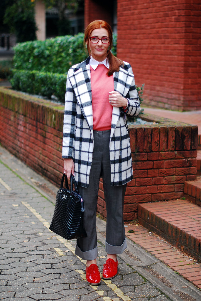 Black & white check coat, coral sweater, red brogues