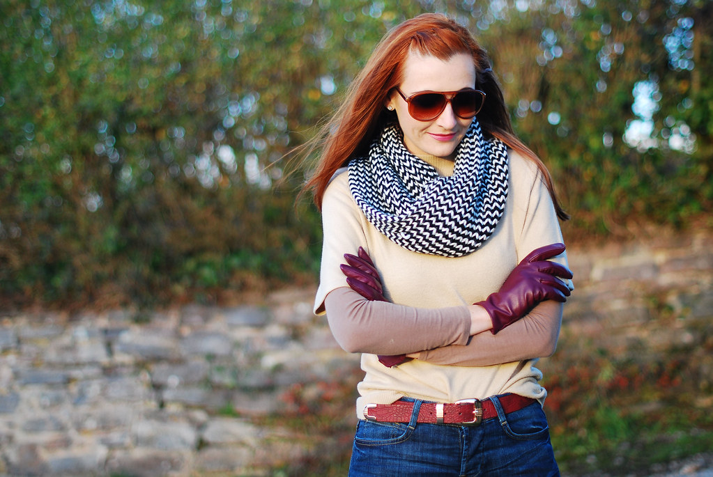 Layered knitwear with plum gloves