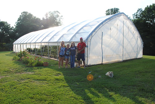 Chris and Tracy Adams with their daughters Ashley and Abigail in front of their high tunnel.