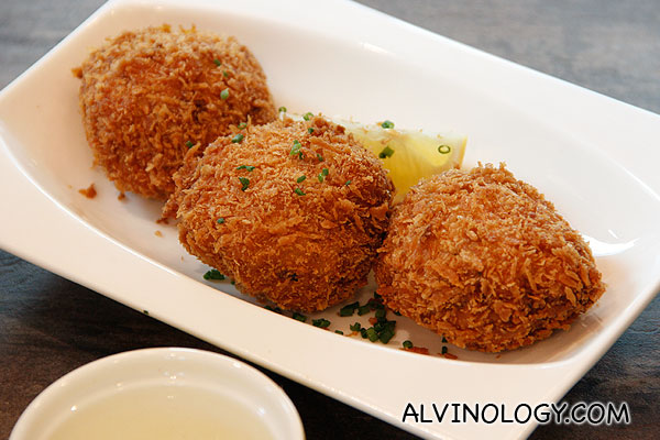 CRAB CAKES (Three potato fritters stuffed with large  chunks of crab claw meat, deep fried and served with lemon) - S$12.90