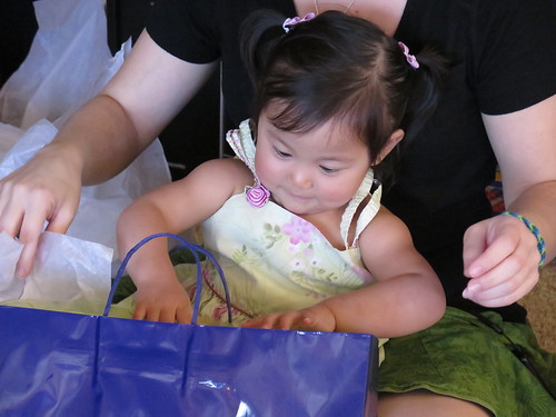 She had fun opening her gifts and throwing the tissue paper around.