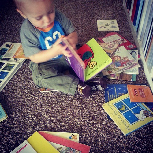 When all is quiet this is where I find him.  Surrounded by all the books hes pulled off the shelf. #lovehim