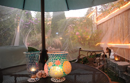 When twilight arrives the lights come on, mosquito netting, patio furniture, lamps, under the umbrella, A Garden for the Buddha, Seattle, Washington, USA by Wonderlane