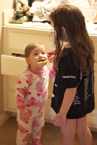 Big Sister Helping Little Sister Brush her teeth