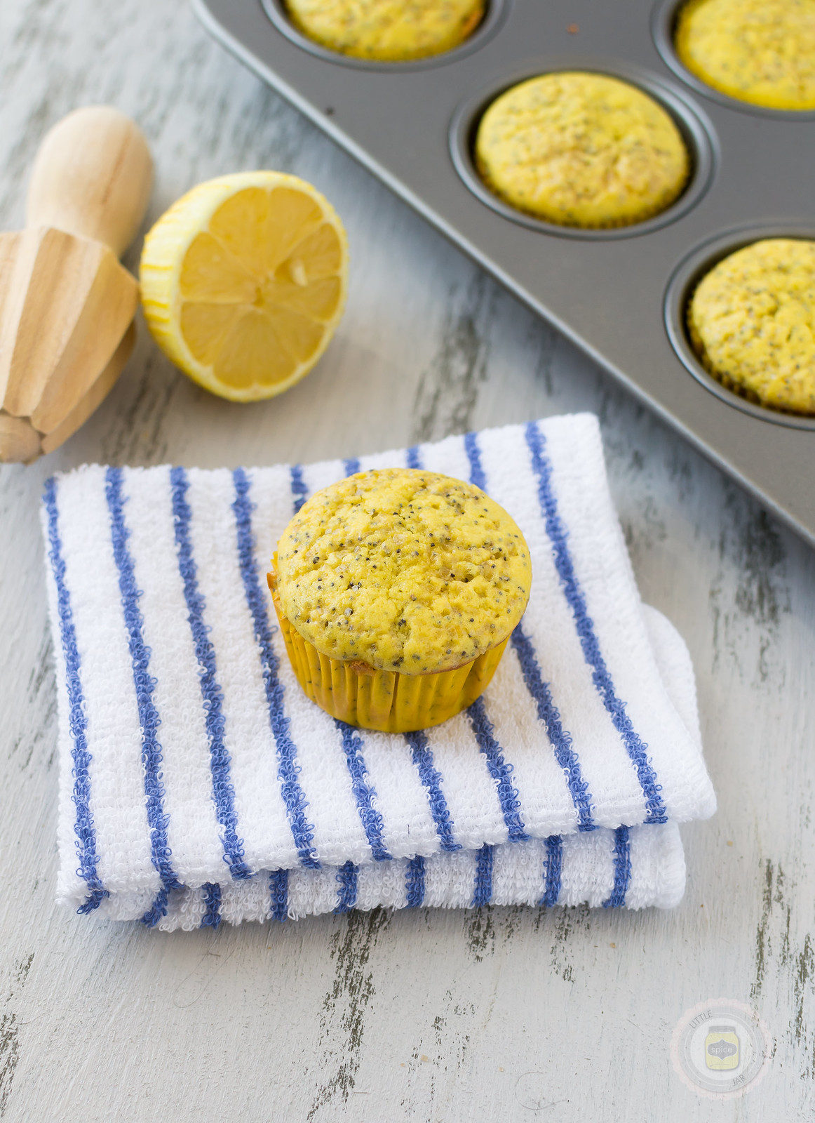 baked muffin on striped hand towel on white surface