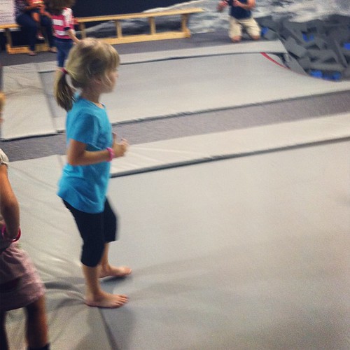 My super cautious girl getting ready to jump off a trampoline into a pit of foam blocks.