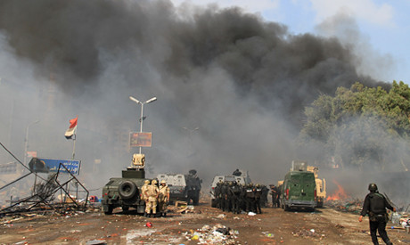 Egyptian military forces attacking an anti-coup encampment in Nasr City, Cairo. Many were killed and injured on August 14, 2013. by Pan-African News Wire File Photos