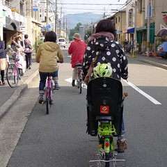 Kyoto Mother Cycling with child on back