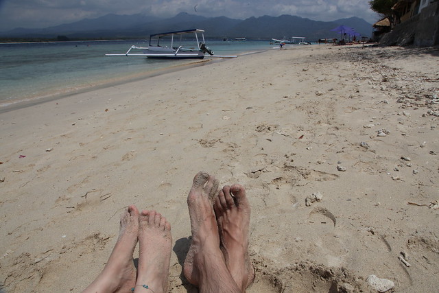 Feet on beach in Gili Islands, Lombok, Indonesia