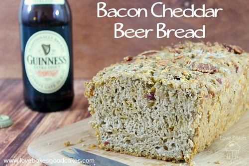 Bacon Cheddar Beer Bread loaf close up with a bottle of Guinness.