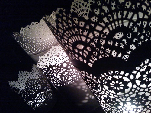 White lace-like metal luminaries, light playing from votive candles, Seattle, Washington, USA by Wonderlane