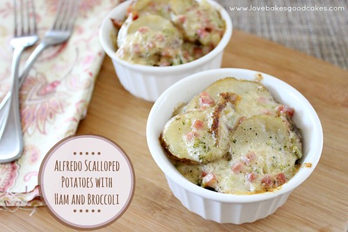 Alfredo Scalloped Potatoes with Ham and Broccoli in white bowls with forks.