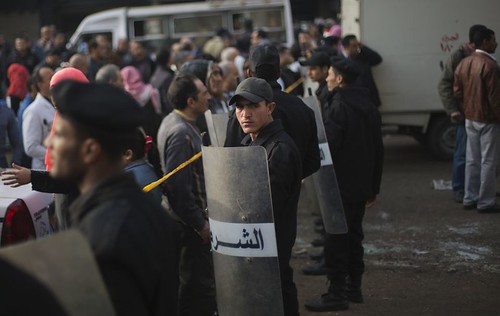 Egyptian riot police clashes with anti-militarists during the first day of voting in the referendum for the amended constitution. 11 were killed on January 14, 2014. by Pan-African News Wire File Photos