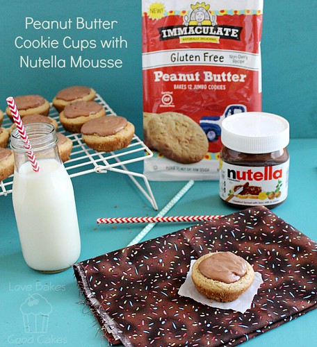 Peanut Butter Cookie Cups with Nutella Mousse on cooling rack and place mat with glass of milk and straw.