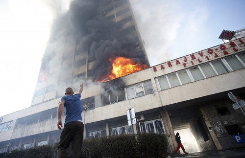 Building set alight by protesters in Tuzla, Bosnia. People are rebelling against unemployment rates of over 44 percent. by Pan-African News Wire File Photos