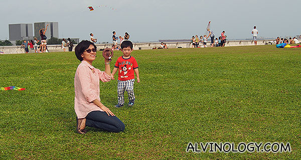 Rachel flying a kite while Asher watches 