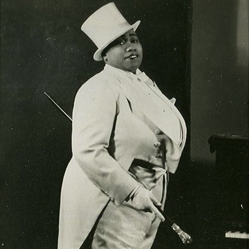 Bentley, a large black woman, in a fancy white tuxedo and top hat