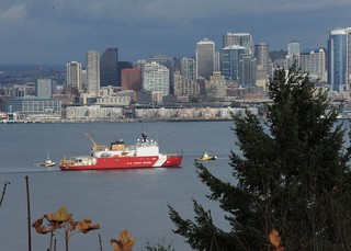 Coast Guard Cutter Healy, a 420-foot polar icebreaker homeported in Seattle, meets two tugboats in Puget Sound, Nov. 5, 2013. Commissioned in 1999, CGC Healy acts as a research platform for scientists in the Arctic and polar regions, as well maintaining search and rescue, environmental protection and law enforcement capabilities. U.S. Coast Guard photo by Petty Officer 3rd Class Katelyn Tyson.