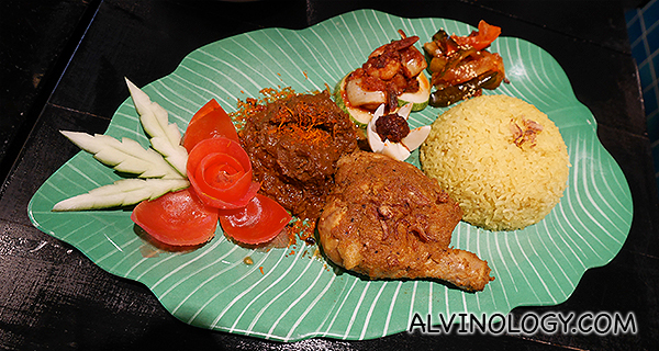 Nasi Peranakan Istimewa (Fragrant kunyit Rice served with soup, Chicken Rendang, prawn sambal, Achar, Keropok, Coconut Serunding, and curry.)