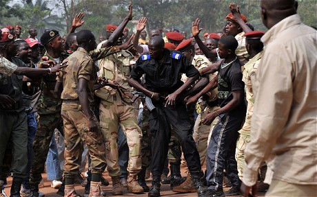 Central African Republic soldiers surround a policeman who sought to intervention to prevent the murder of a man accused of being a Seleka rebel. The incident occurred on Feb. 5, 2014. by Pan-African News Wire File Photos