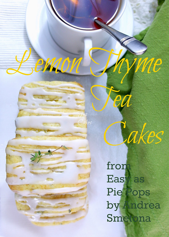 A Lemon Thyme Tea Cake on a white napkin next to a white cup of tea with a spoon resting in it. Text reads: Lemon Thyme Tea Cakes from Easy as Pie Pops by Andrea Smetona.