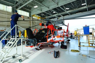 Coast Guard aviation maintenance technicians and avionics electricians perform routine maintenance on an MH-65 Dolphin helicopter at the air station hangar Oct. 17, 2013. The helicopters used by the air station are all carefully watched and maintained by well-trained flight mechanics and electricians who troubleshoot and maintain them daily. (U.S. Coast Guard photo by Petty Officer 3rd Class Carlos Vega)