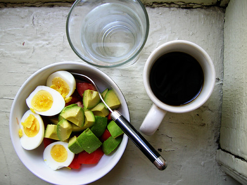 hardboiled eggs, avocado and tomato, water, coffee