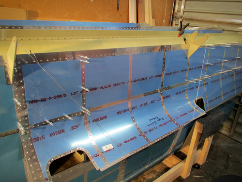 Riveting begins on the right wing's outboard bottom skin.  3/16 panels done.