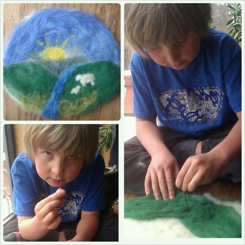 We brought out the wool and made a little "wool painting" together for Imbolc. This was Asher's first time needle felting.