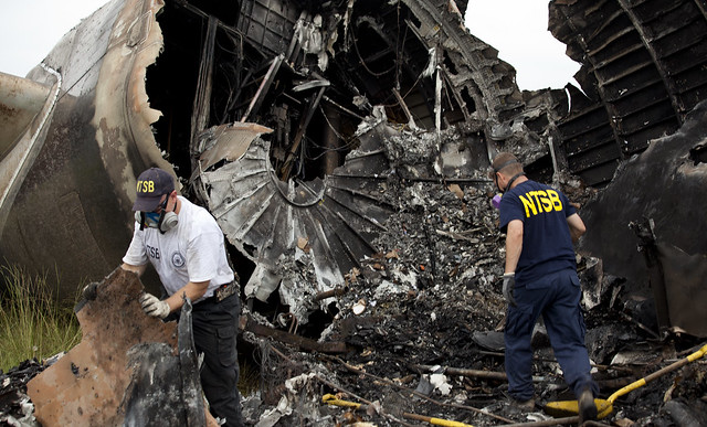 NTSB investigators Clint Crookshanks and Steve Magladry examining wreckage from UPS flight 1354